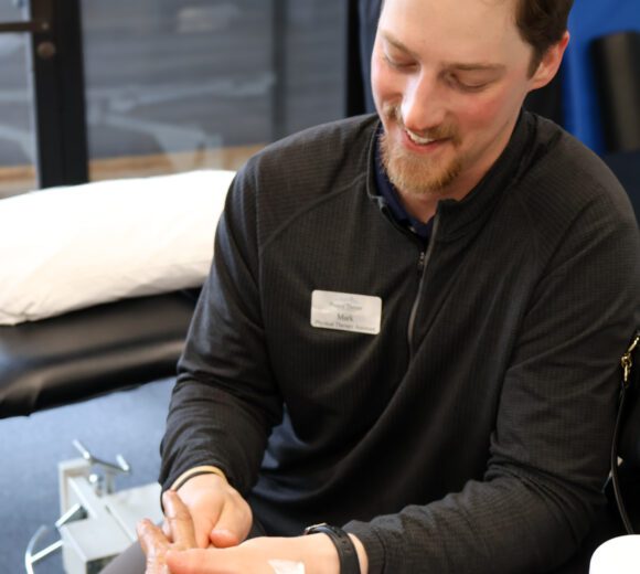 Hand therapy performed by a physical therapist on a woman at physical therapy of the Rockies